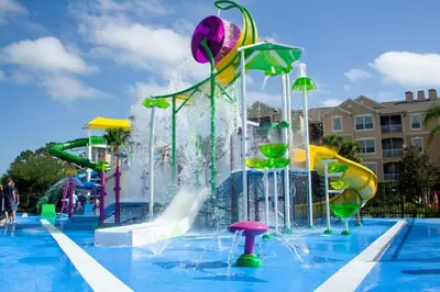 a pool with a water park with a water slide at Incredible Condo - 5 Min to Disney Windsor Hills in Orlando