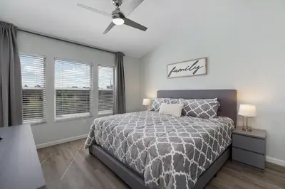 a bedroom with a bed and a ceiling fan at Charming 3BR Townhome Private Pool Walk to Clubhouse 9 Min Disney in Orlando