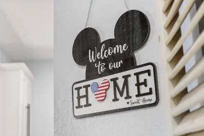a sign that says welcome to our home on a wall at Windsor Hills Dream - 3BR - 2 miles from Disney in Orlando