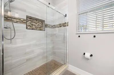 a bathroom with a shower with a glass door at Windsor Hills Dream - 3BR - 2 miles from Disney in Orlando