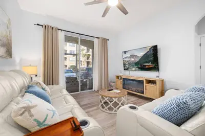 a living room with white furniture and a flat screen tv at Windsor Hills Dream - 3BR - 2 miles from Disney in Orlando