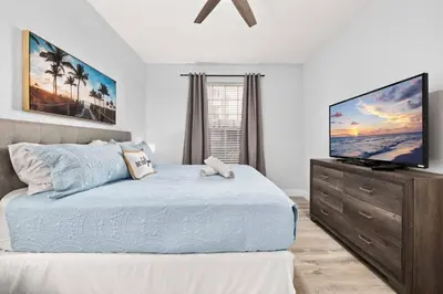 a bedroom with a bed and a flat screen tv at Windsor Hills Dream - 3BR - 2 miles from Disney in Orlando