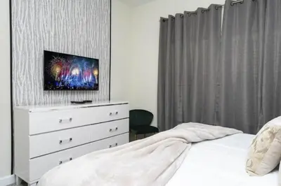 a bedroom with a bed and a dresser with a tv on it at Amazing Villa 5BR Heated Pool Themed Rooms - 5 miles Disney in Kissimmee