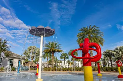 a red sculpture in front of a water fountain at Lake View - 10 min to Disney Storey Lake Resort in Kissimmee
