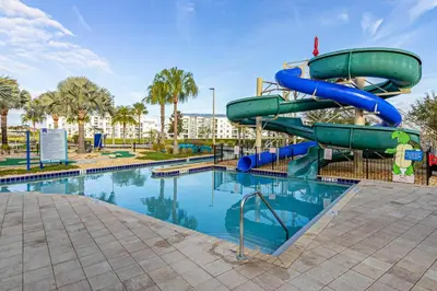 a water slide in a park with a swimming pool at Lake View - 10 min to Disney Storey Lake Resort in Kissimmee
