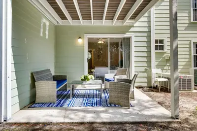 a patio with a table and chairs on a house at Condo with Pool Access and Patio 8 Mi to Disney! in Kissimmee