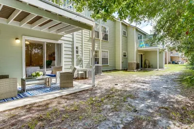 a house with a patio with a table and chairs at Condo with Pool Access and Patio 8 Mi to Disney! in Kissimmee