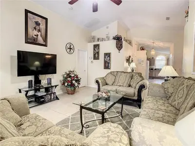 a living room with two couches and a tv at Magic Orlando Villa, You are in Disney in Kissimmee